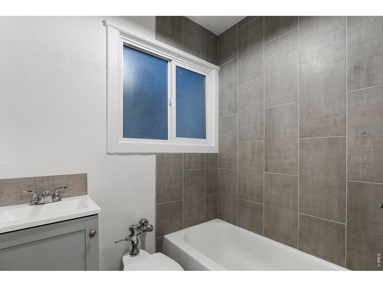 1416 North Downing Street, Unit 2 Denver, CO 80218 - Photo 12 of 12 a bathroom with a sink a toilet and mirror