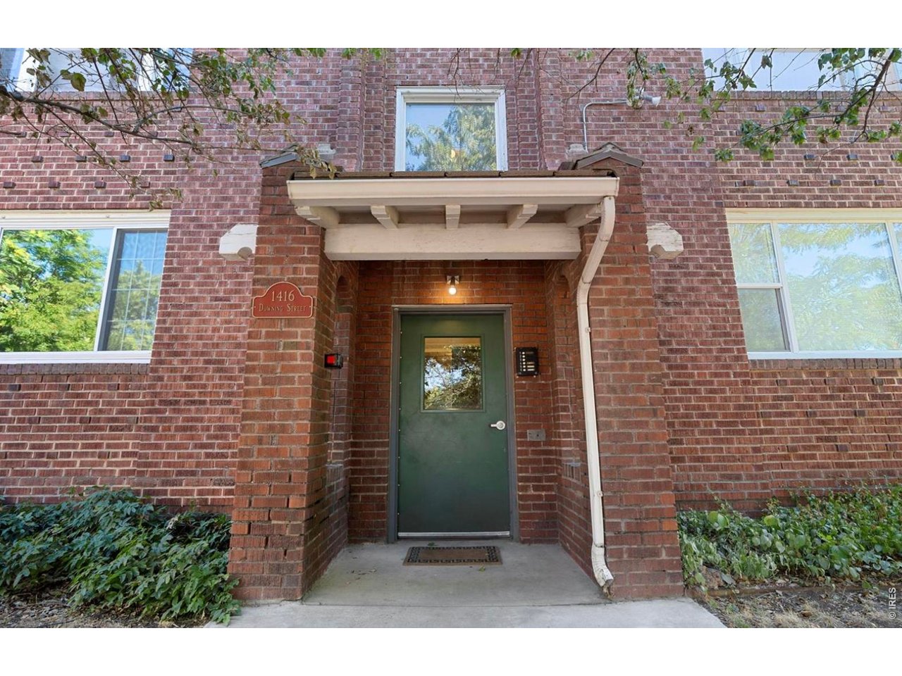 1416 North Downing Street, Unit 2 Denver, CO 80218 - Photo 3 of 12 a front view of a house with a garden