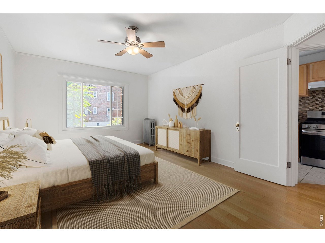 1416 North Downing Street, Unit 2 Denver, CO 80218 - Photo 7 of 12 a bedroom with a bed and a chandelier