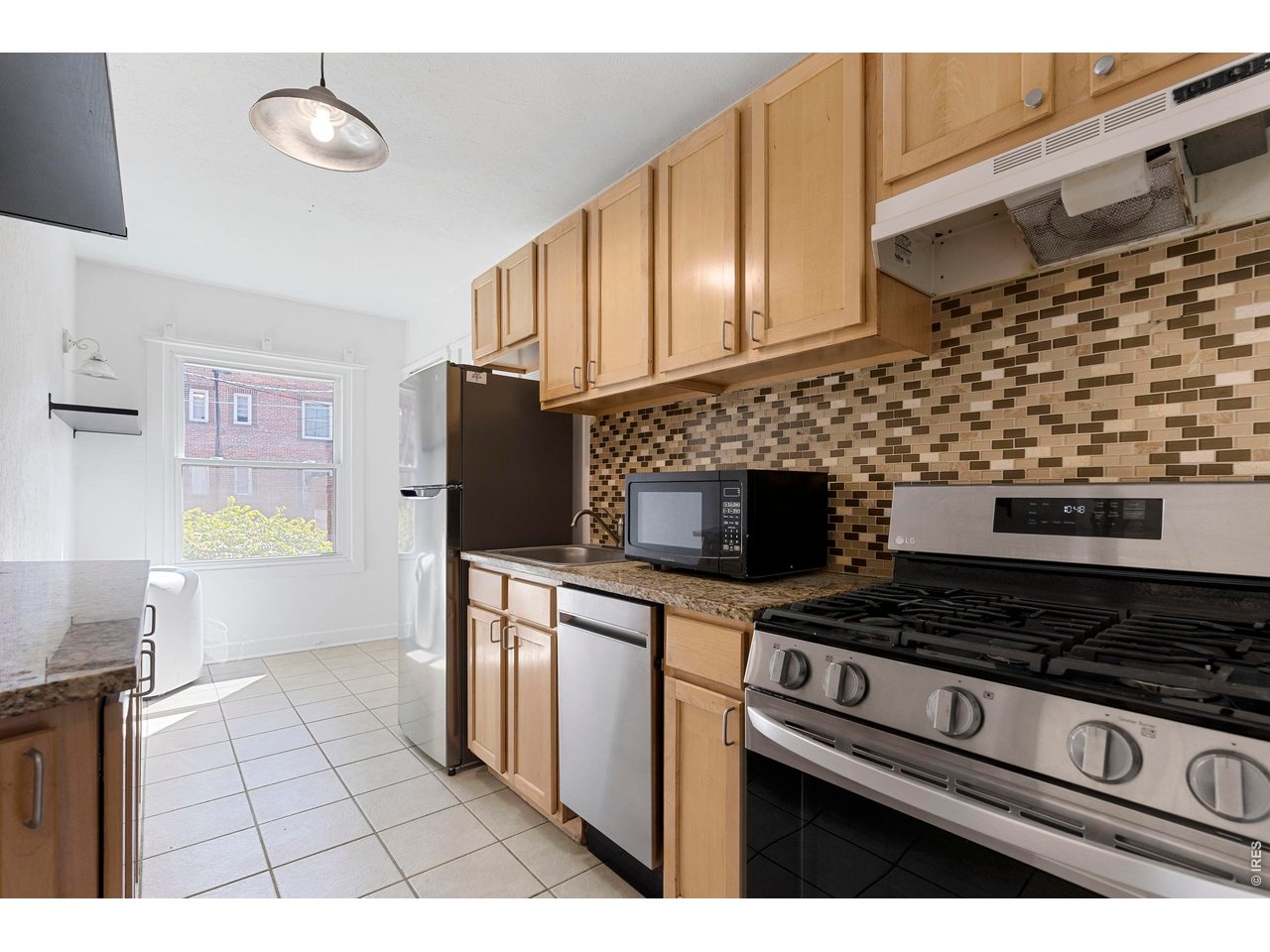 1416 North Downing Street, Unit 2 Denver, CO 80218 - Photo 9 of 12 a kitchen with stainless steel appliances a stove a sink and a microwave