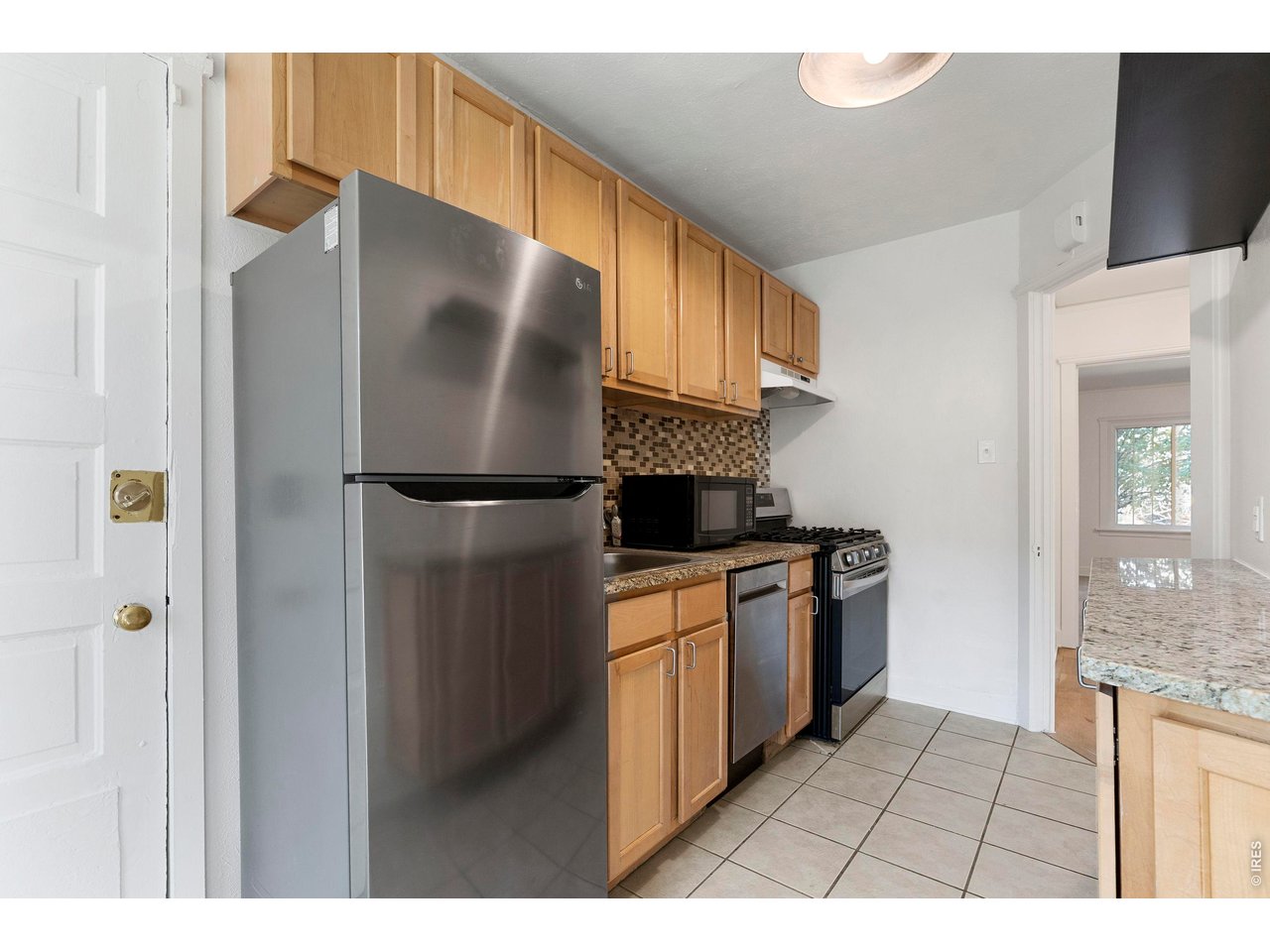 1416 North Downing Street, Unit 2 Denver, CO 80218 - Photo 10 of 12 a kitchen with stainless steel appliances granite countertop a refrigerator a stove and a sink