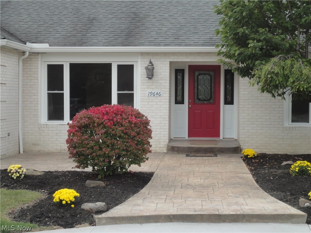 19646 Prospect Road Strongsville, OH 44149 - Photo 4 of 32 Front stamped walkway to house from circular drive or to left the garage. There is room on the patio to set chairs and a table in front of dining room window to left side.