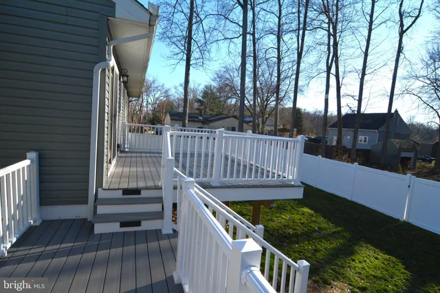 a view of balcony with wooden floor and fence