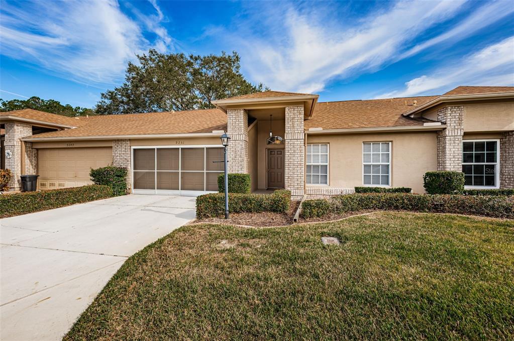 9251 Clearmeadow New Port Richey, FL 34655 - Photo 1 of 1 a front view of a house with garden and porch