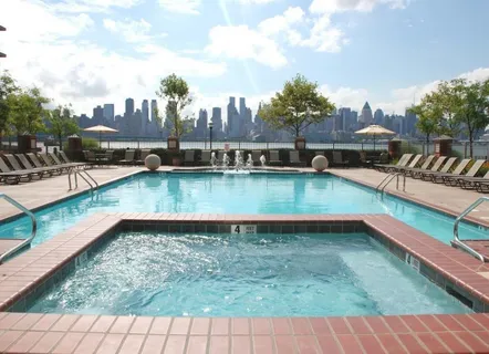 a view of a swimming pool with outdoor seating