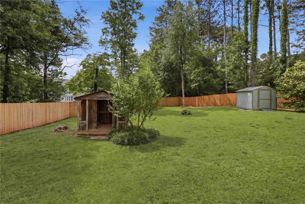 338 Arbour Way Suwanee, GA 30024 - Photo 25 of 32 a view of a backyard with potted plants and large trees