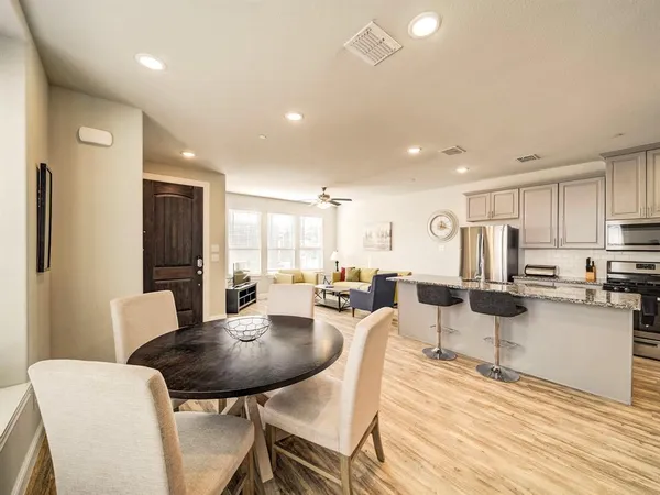 a view of a dining room with furniture and wooden floor