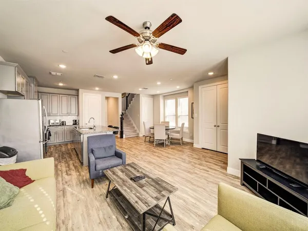 a living room with furniture a dining table and kitchen view