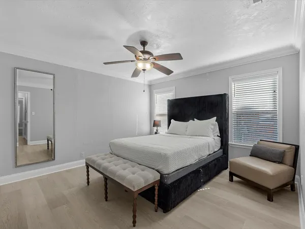 a spacious bedroom with a bed and a couch