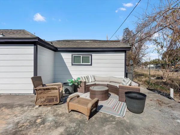 a view of a patio with a table and chairs