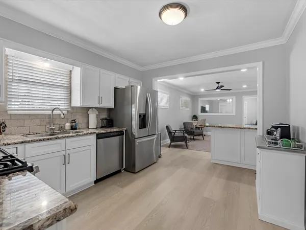a kitchen with refrigerator and cabinets