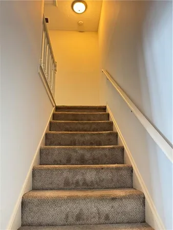 a view of staircase with white walls