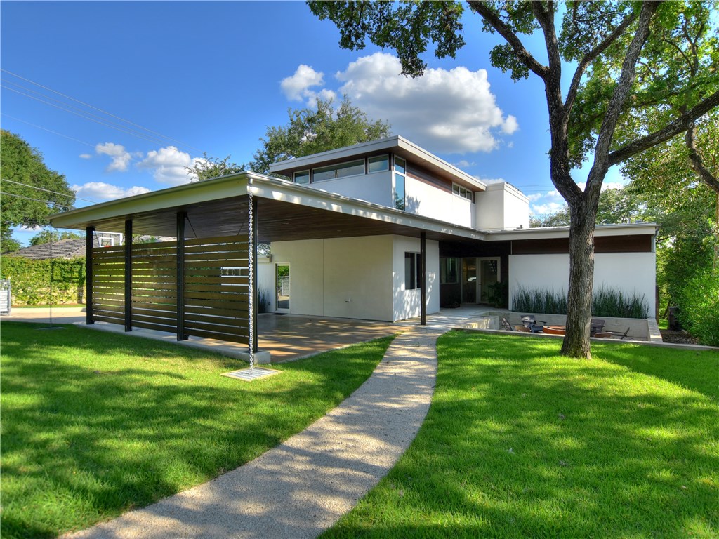 a view of a house with a yard and tree s
