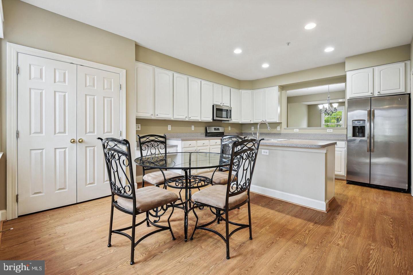 337 Main Street Gaithersburg, MD 20878 - Photo 5 of 35 a kitchen with stainless steel appliances granite countertop a dining table chairs refrigerator and sink