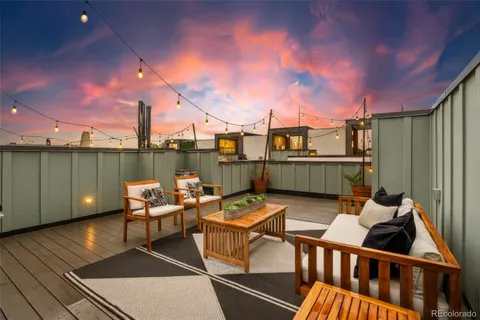 a terrace with outdoor seating and city view