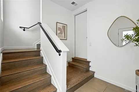 a view of entryway and hall with wooden floor