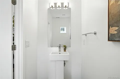 a bathroom with a sink a mirror and shower