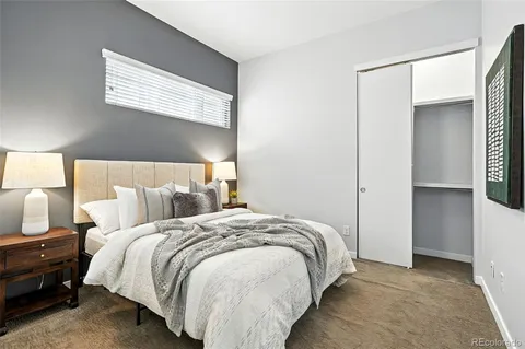 a bed room with a bed and a night stand