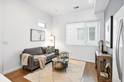 a living room with furniture and a floor to ceiling window