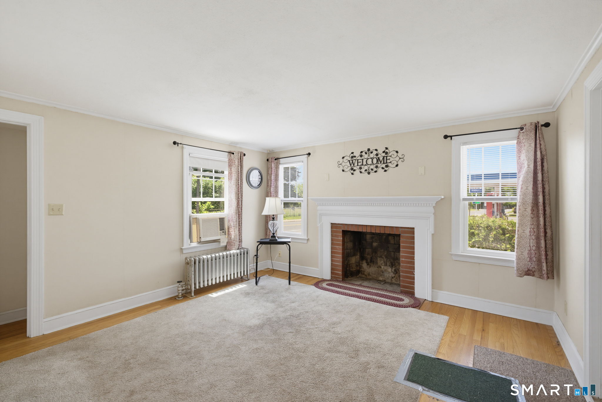 417 Hartford Road Manchester, CT 06040 - Photo 11 of 38 Living room with hardwood floors under area rug.