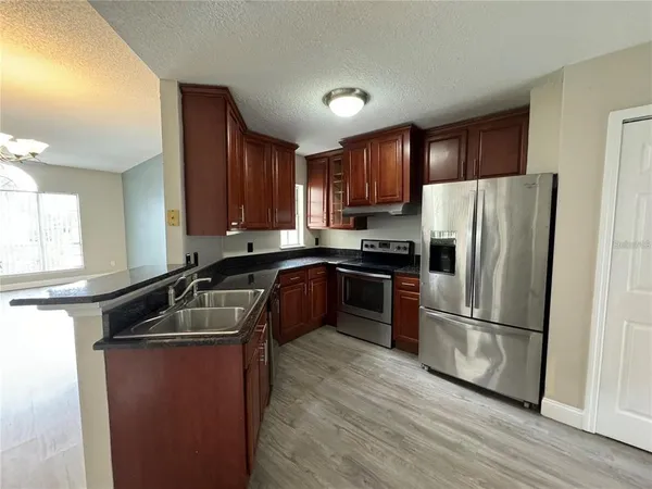 a kitchen with a refrigerator sink and microwave