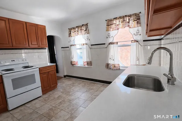a kitchen with a sink cabinets and appliances
