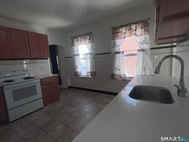 a kitchen with sink refrigerator and window