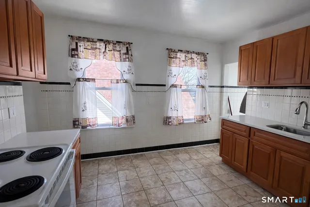 a kitchen with stainless steel appliances a sink and a refrigerator