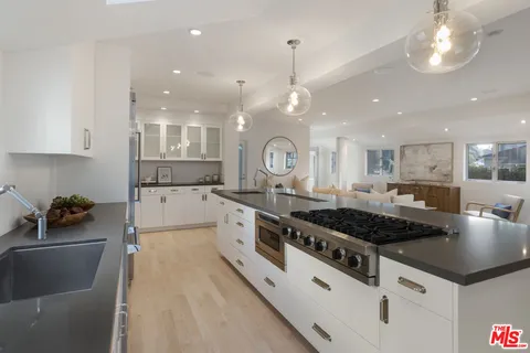 a kitchen with stainless steel appliances granite countertop a stove and a sink