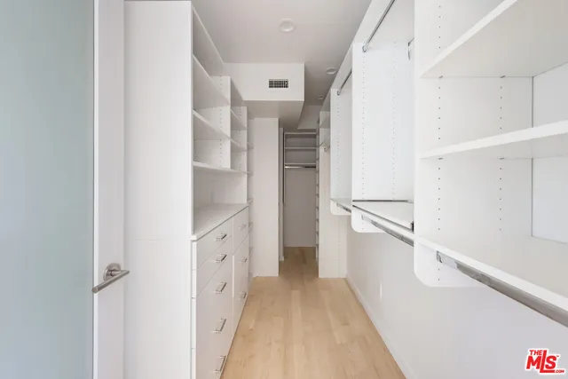 a view of walk in closet with white walls