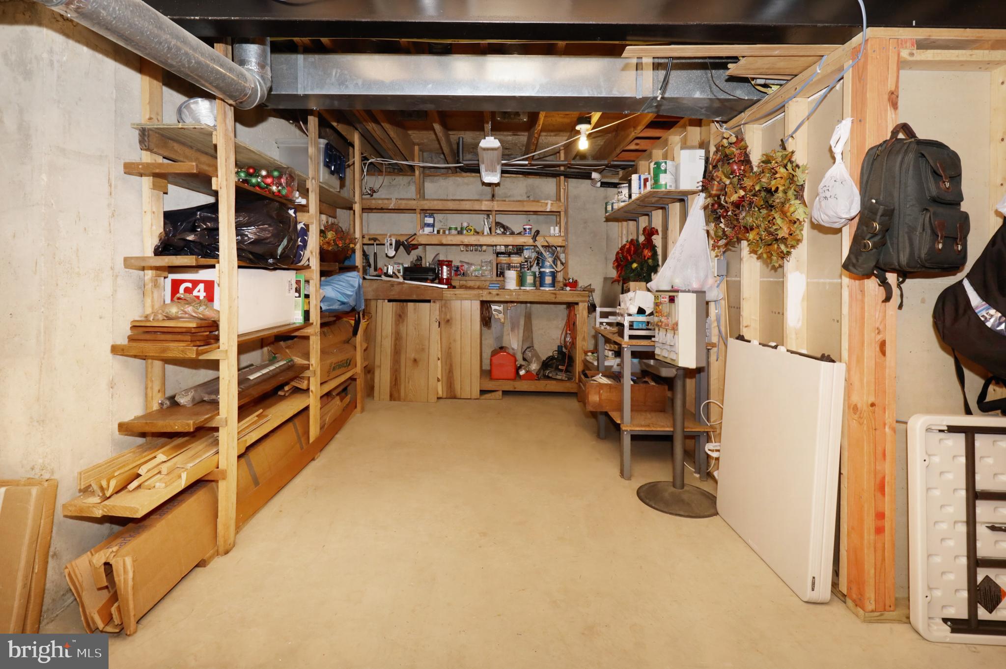 7616 Bertito Lane Springfield, VA 22153 - Photo 49 of 54 Storage Room with Workbench & Wood Shelving