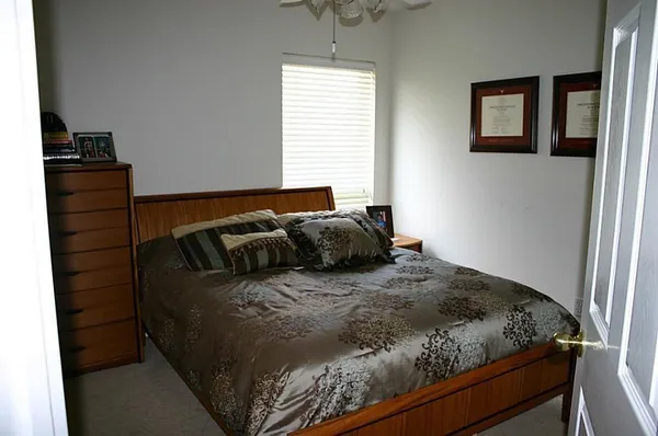 a bed sitting in a bedroom next to a window