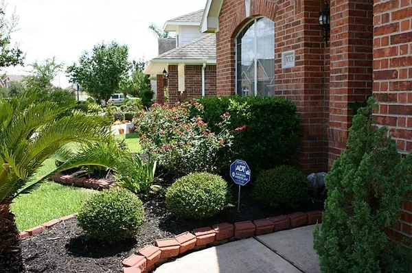 a front view of a multi story residential apartment building with a yard