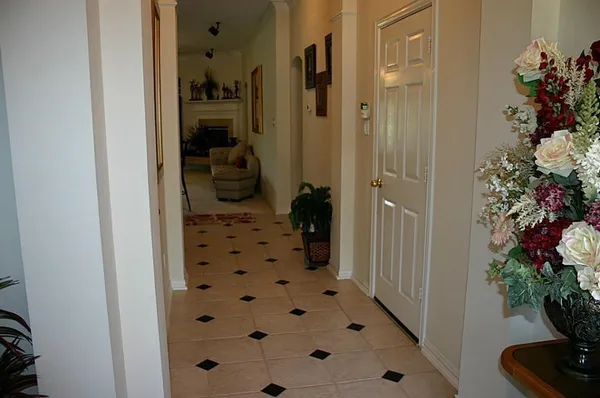 a view of a hallway with a flower pot