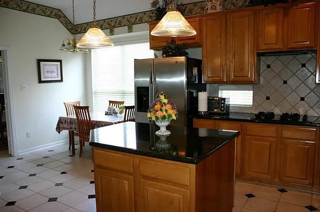 a kitchen with stainless steel appliances granite countertop a sink and cabinets