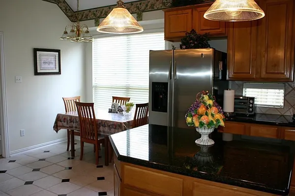 a kitchen with a table and chairs