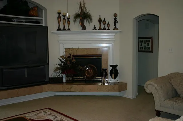 a view of living room with furniture and a fireplace