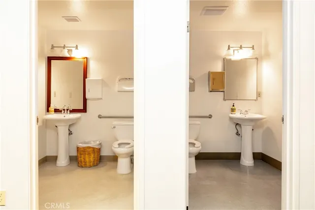 a bathroom with a sink toilet and a mirror