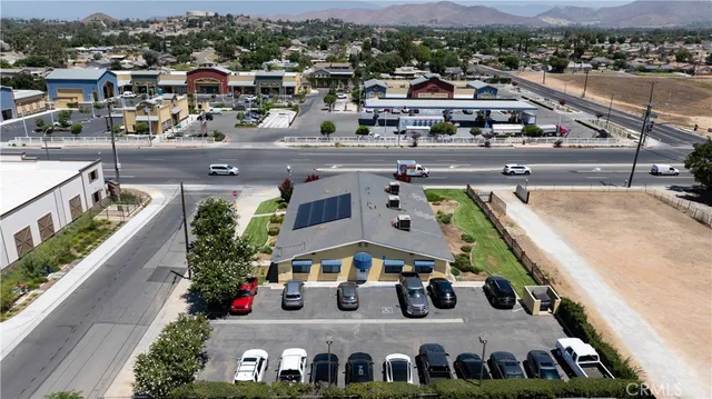 an aerial view of a residential apartment building with a yard and garage