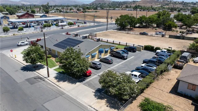 an aerial view of a house with a garden and lake view