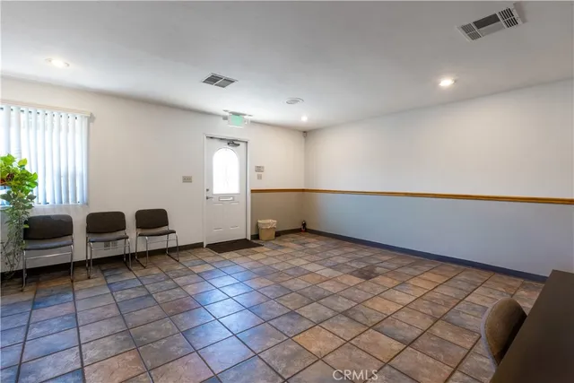 a room with furniture pool table and a window