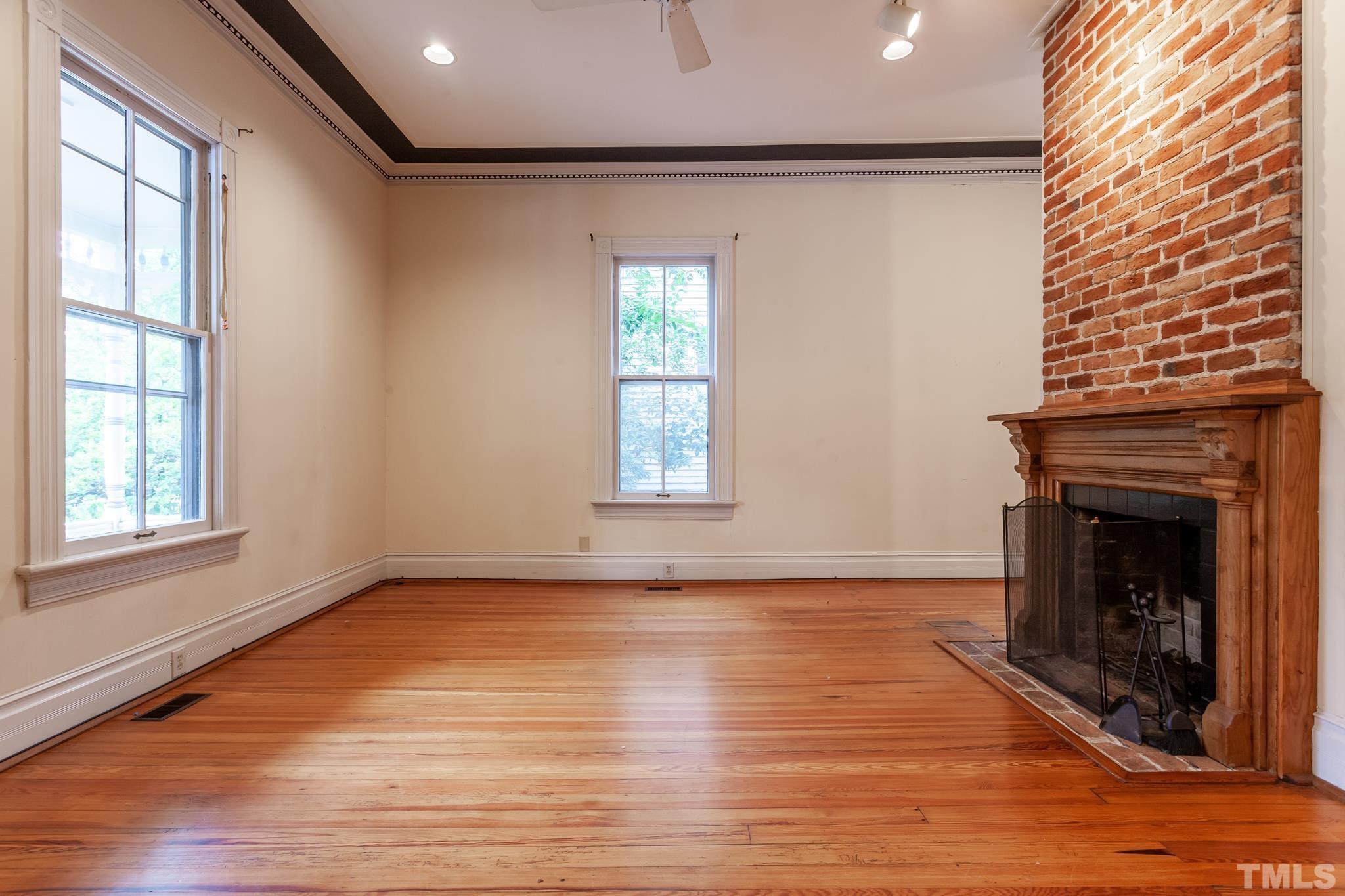 323 East Lane Street Raleigh, NC 27601 - Photo 12 of 42 a view of an empty room with wooden floor and a window