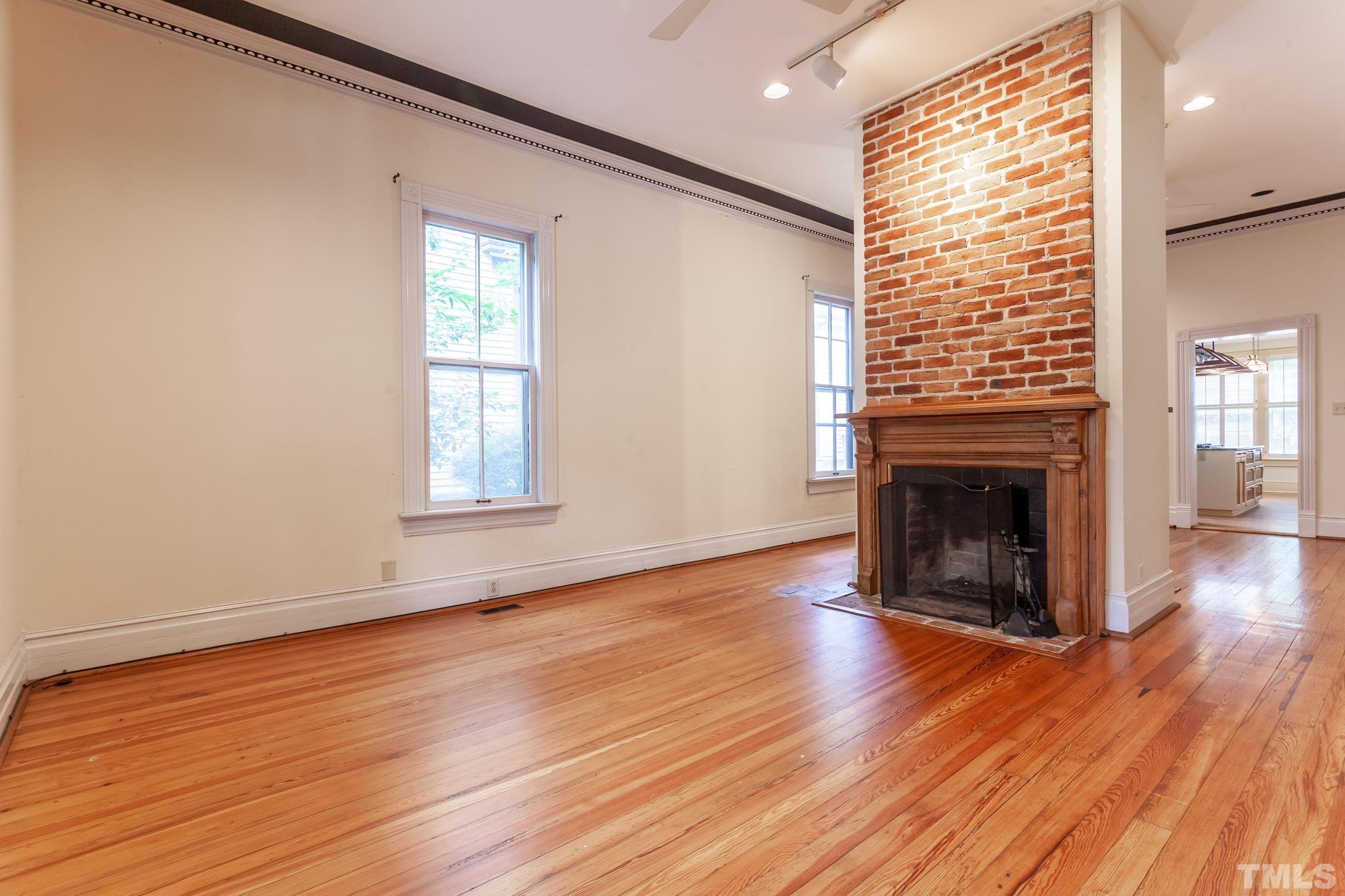 323 East Lane Street Raleigh, NC 27601 - Photo 14 of 42 a view of an empty room with wooden floor and a window