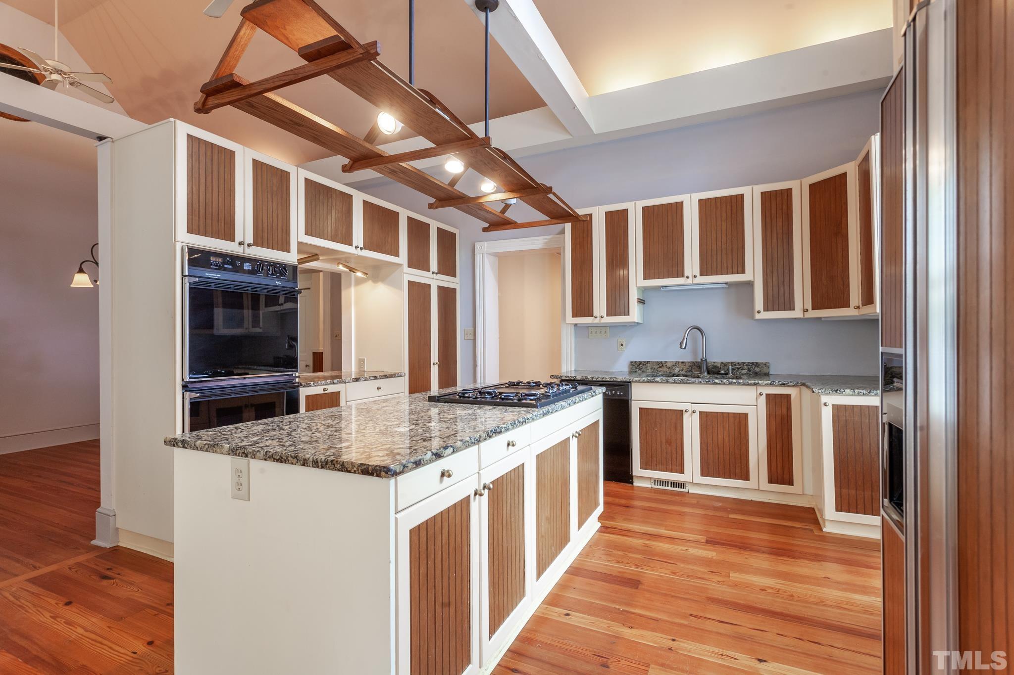 323 East Lane Street Raleigh, NC 27601 - Photo 21 of 42 a kitchen with stainless steel appliances granite countertop a stove and cabinets