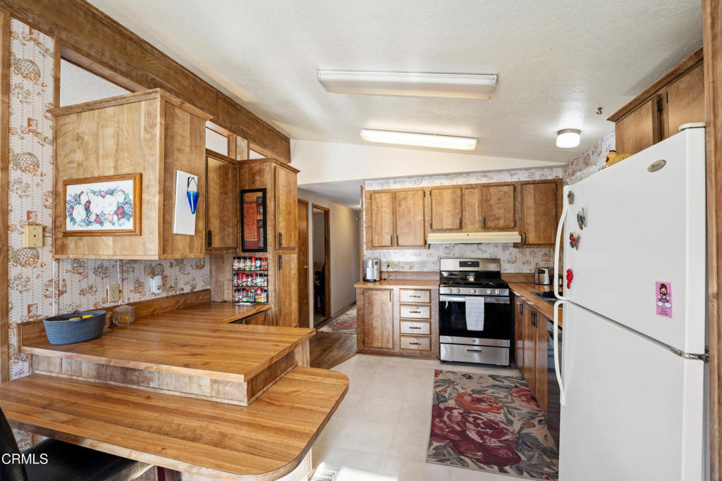 975 West Telegraph Road, Unit 10 Santa Paula, CA 93060 - Photo 8 of 21 a kitchen with stainless steel appliances granite countertop a refrigerator and a stove