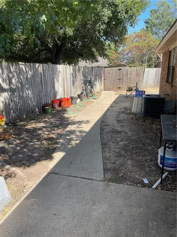 a view of a backyard with furniture and a tree