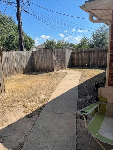 a backyard of a house with table and chairs