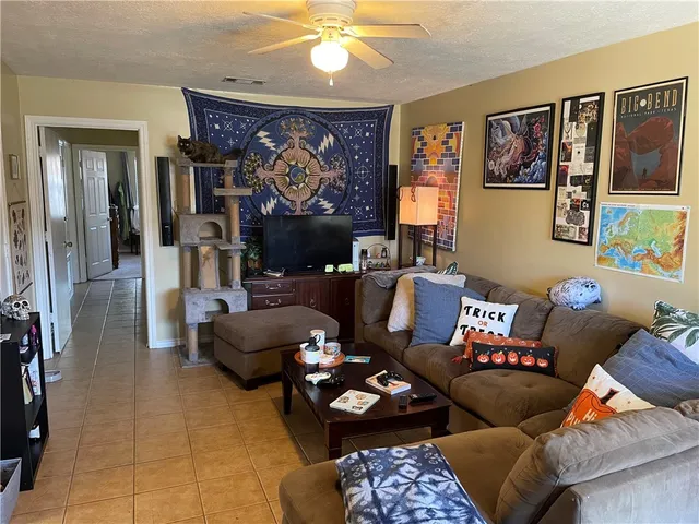 a living room with furniture and a chandelier