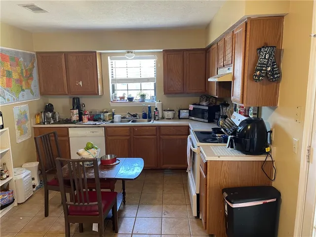 a view of a kitchen with a dining table and chairs