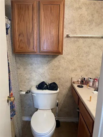 a bathroom with a toilet a sink and a window